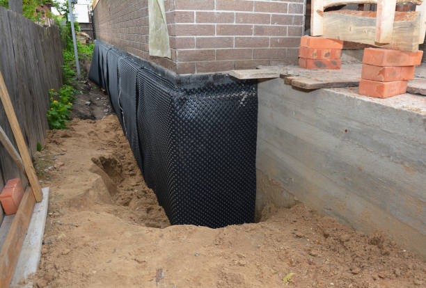 Happy homeowners after waterproofing job in North Chili